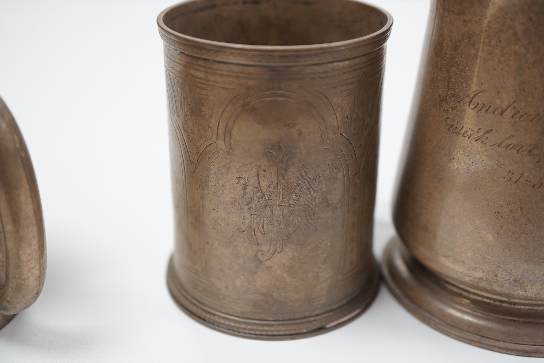 A Victorian engraved silver christening mug, The Barnards, London, 1871, 82mm and two later silver mugs, 14oz.